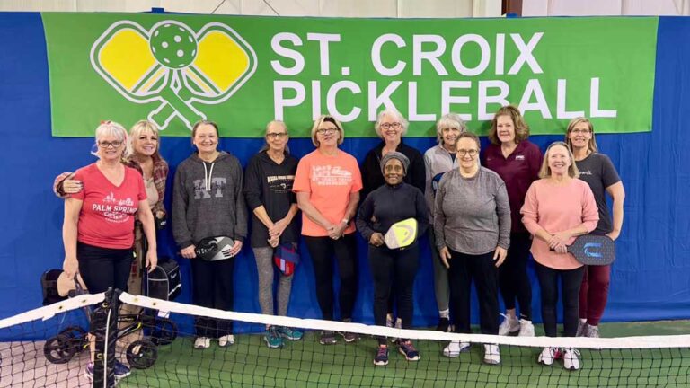 A diverse group of ladies some holding pickleball racquets